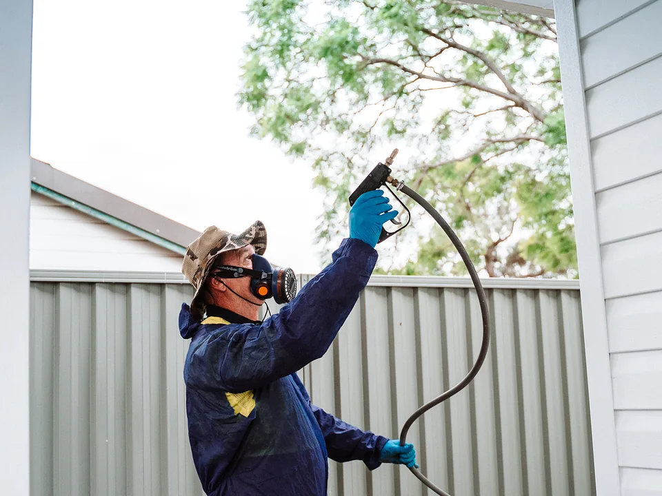 Bug Free technician applying a perimeter treatment to the eaves of a Sydney home