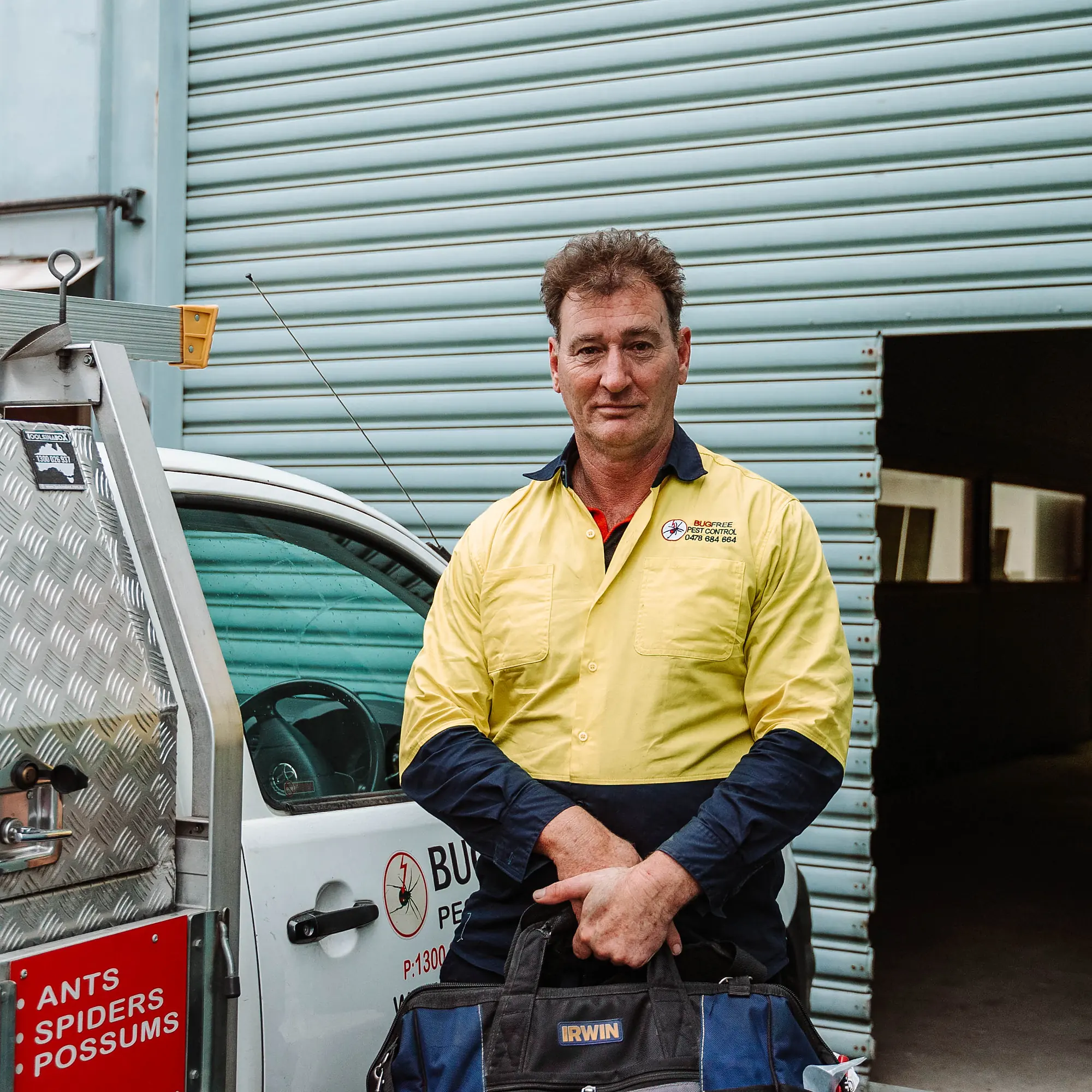 Bug Free technician at an industrial site with the service vehicle